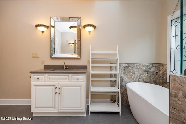 11308 Bodley Dr, Louisville, KY 40223 - full bathroom with a freestanding tub, vanity, tile patterned flooring, tile walls, and a wainscoted wall