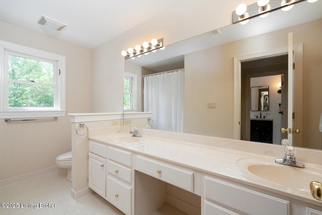 11308 Bodley Dr, Louisville, KY 40223 - bathroom featuring toilet, baseboards, double vanity, and tile patterned flooring