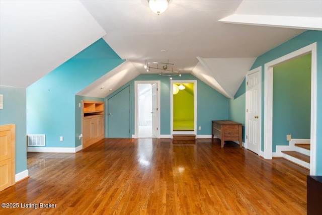 11308 Bodley Dr, Louisville, KY 40223 - additional living space with vaulted ceiling, wood finished floors, stairway, and baseboards