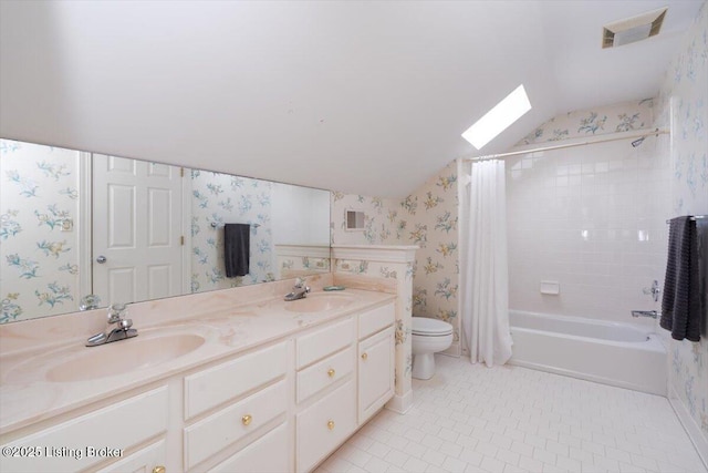 11308 Bodley Dr, Louisville, KY 40223 - full bathroom with lofted ceiling, wallpapered walls, a skylight, toilet, and double vanity
