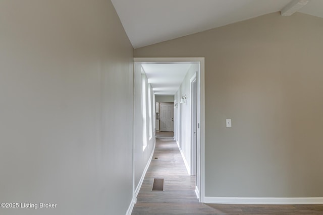 hallway featuring wood finished floors and baseboards