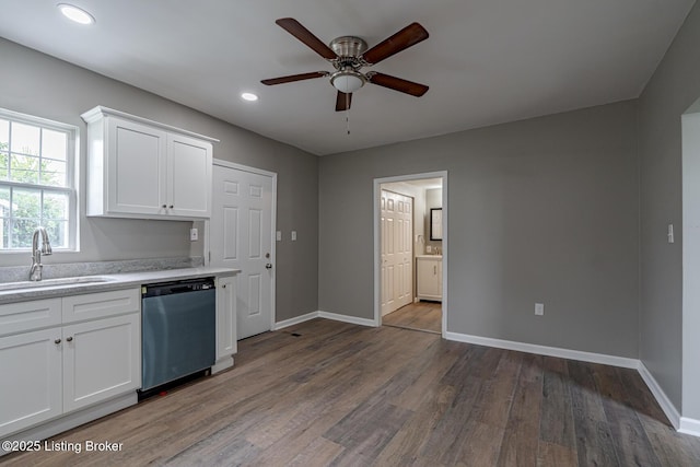 kitchen featuring dishwasher, a sink, ceiling fan, wood finished floors, and baseboards