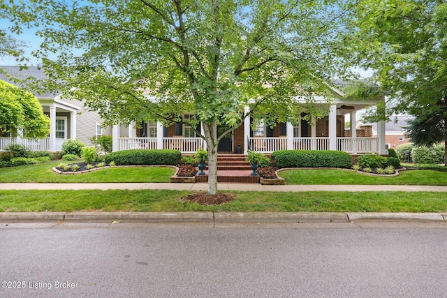 9144 Cranesbill Trce, Prospect, KY 40059 - view of property hidden behind natural elements featuring covered porch, a front yard, and brick siding