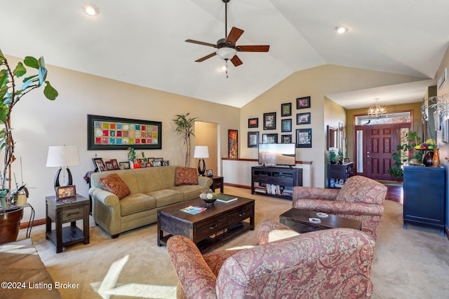 living room featuring light colored carpet, lofted ceiling, a ceiling fan, baseboards, and a chandelier