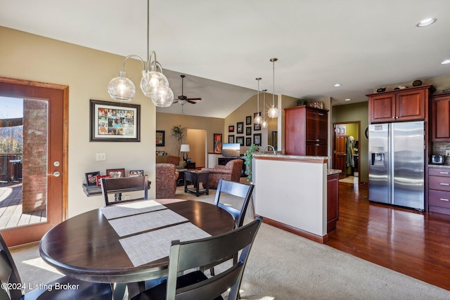 dining area with ceiling fan, vaulted ceiling, dark carpet, recessed lighting, and dark wood finished floors