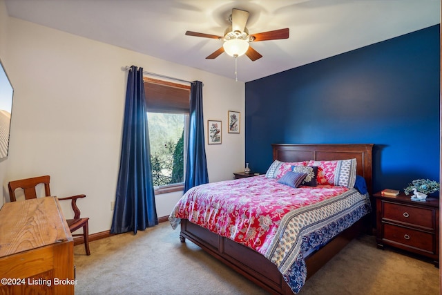 carpeted bedroom with ceiling fan and baseboards