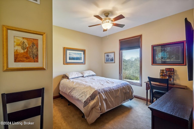 carpeted bedroom featuring baseboards and a ceiling fan