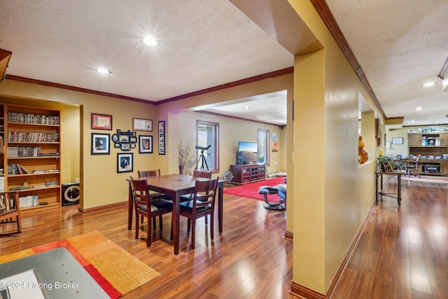 dining room with a textured ceiling, wood-type flooring, ornamental molding, baseboards, and recessed lighting
