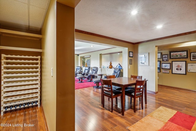 dining area featuring ornamental molding, wood finished floors, baseboards, and recessed lighting