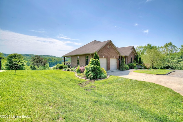 view of front of property featuring brick siding, an attached garage, a front yard, and driveway