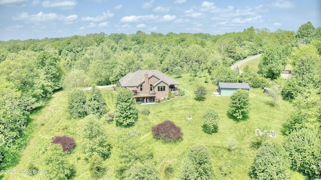 view from above of property with a heavily wooded area