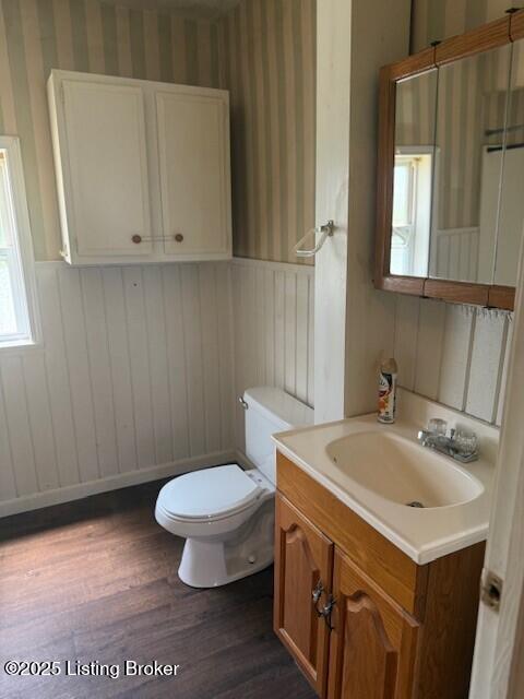 229 Beech Grove Rd, Shepherdsville, KY 40165 - half bath with wallpapered walls, wainscoting, wood finished floors, toilet, and vanity