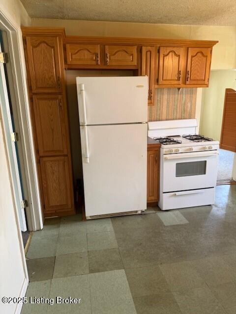 229 Beech Grove Rd, Shepherdsville, KY 40165 - kitchen with white appliances, brown cabinetry, and tile patterned floors