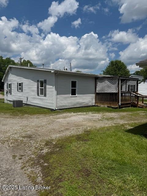 229 Beech Grove Rd, Shepherdsville, KY 40165 - back of house featuring a deck, a yard, central AC unit, and driveway