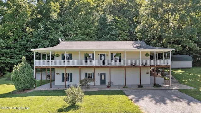 744 Bear Creek Rd, Leitchfield, KY 42754 - view of front of home with a front yard, a storage unit, a patio area, and an outdoor structure