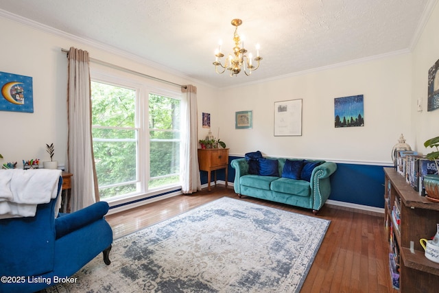 living area with a chandelier, wood-type flooring, ornamental molding, baseboards, and a textured ceiling
