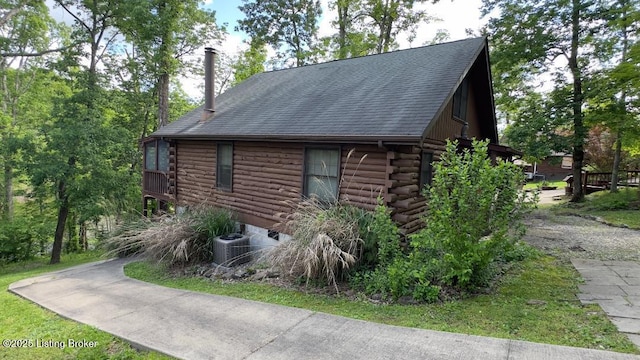403 Timberlake Ln, Mcdaniels, KY 40152 - view of home's exterior featuring log siding, central air condition unit, and a shingled roof
