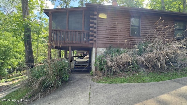 403 Timberlake Ln, Mcdaniels, KY 40152 - view of front facade with log exterior, a sunroom, driveway, and stairway