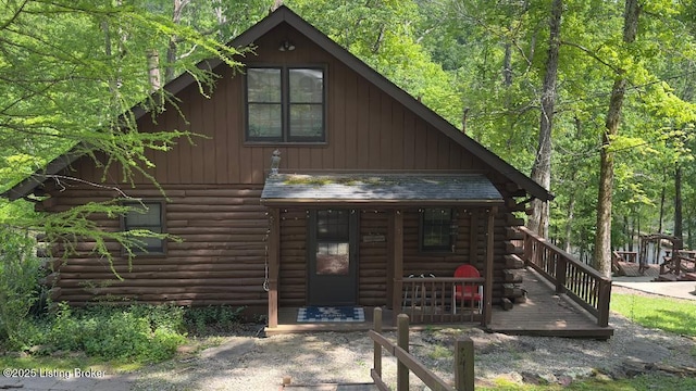 403 Timberlake Ln, Mcdaniels, KY 40152 - view of front facade with log exterior, a view of trees, and a porch