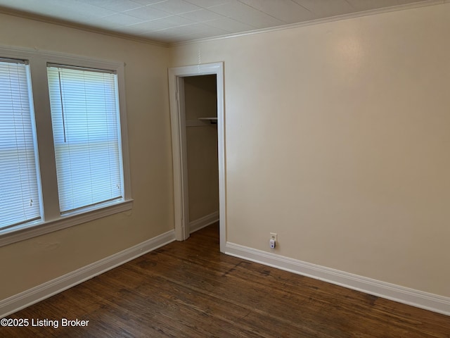 2809 Wyandotte Ave, Louisville, KY 40210 - unfurnished bedroom with dark wood-style floors, baseboards, crown molding, and a closet