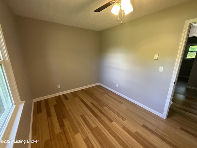 117 Northridge Dr, Bedford, KY 40006 - spare room featuring wood finished floors, baseboards, and ceiling fan