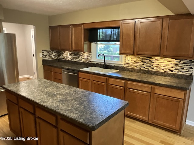 117 Northridge Dr, Bedford, KY 40006 - kitchen with a sink, appliances with stainless steel finishes, light wood-style flooring, dark countertops, and tasteful backsplash