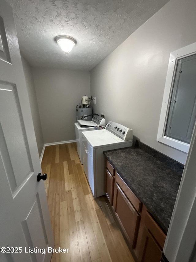 117 Northridge Dr, Bedford, KY 40006 - laundry room featuring light wood-style flooring, washer and dryer, a textured ceiling, baseboards, and cabinet space