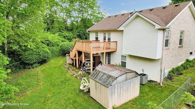 11404 Reality Trl, Louisville, KY 40229 - back of property with a deck, a shed, an outbuilding, brick siding, and a shingled roof