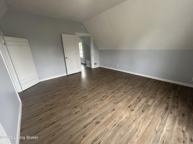 2503 W Main St, Louisville, KY 40212 - additional living space with lofted ceiling, dark wood finished floors, and baseboards