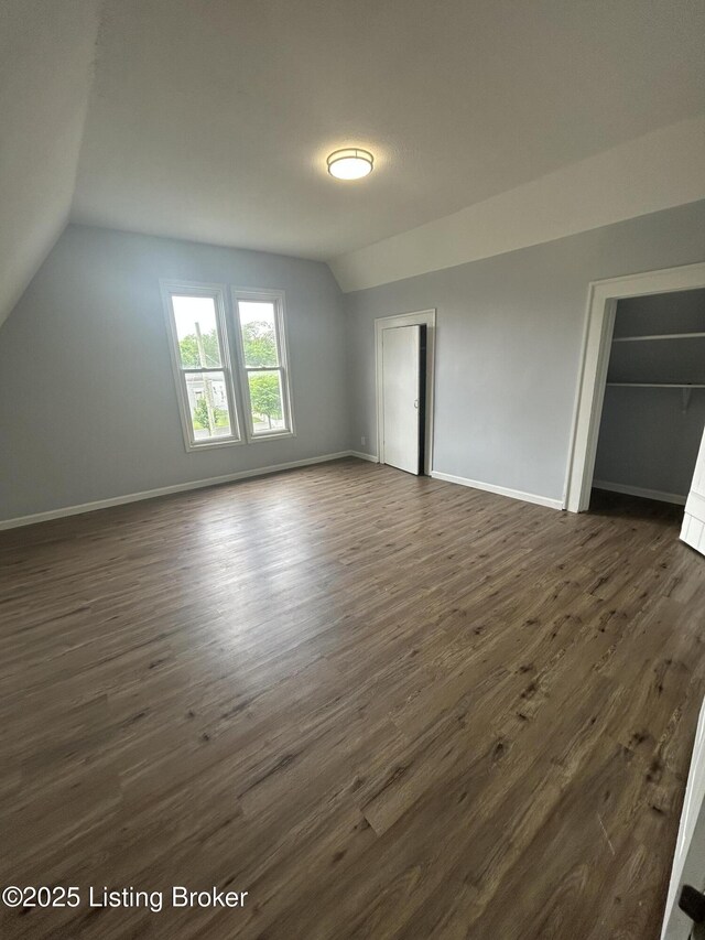 2503 W Main St, Louisville, KY 40212 - unfurnished bedroom with vaulted ceiling, dark wood finished floors, and baseboards