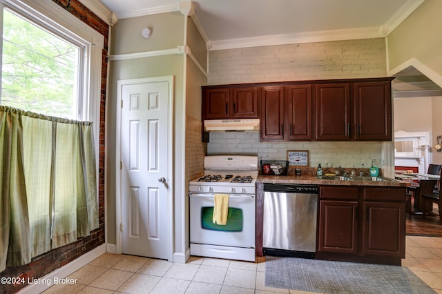 2935 S 3rd St, Louisville, KY 40208 - kitchen featuring stainless steel dishwasher, white gas range oven, under cabinet range hood, a sink, and light tile patterned floors