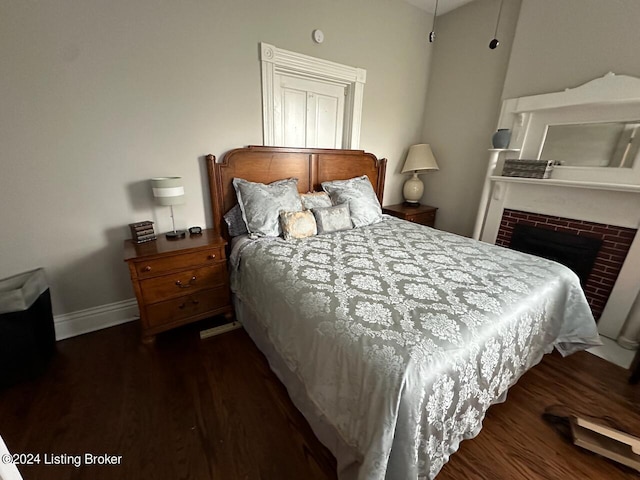 2935 S 3rd St, Louisville, KY 40208 - bedroom with dark wood-type flooring, a brick fireplace, and baseboards