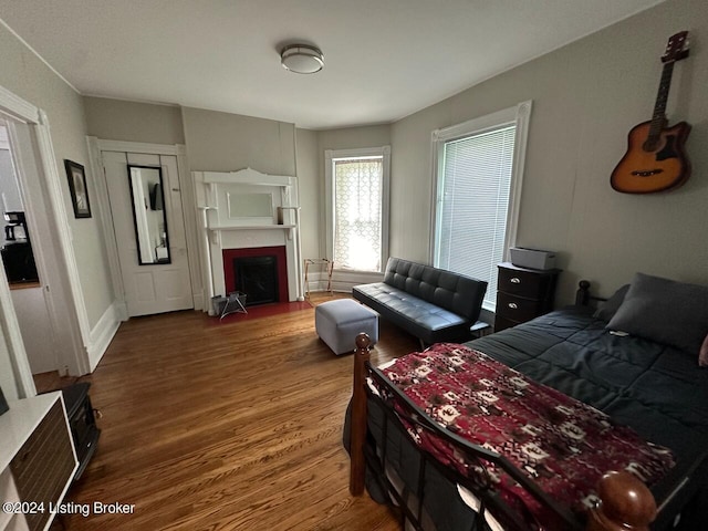 2935 S 3rd St, Louisville, KY 40208 - bedroom with wood finished floors, a fireplace with flush hearth, and baseboards
