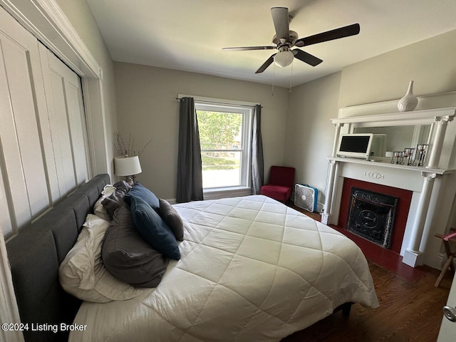 2935 S 3rd St, Louisville, KY 40208 - bedroom with wood finished floors, a fireplace, and a ceiling fan