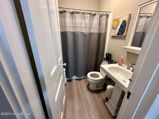 2935 S 3rd St, Louisville, KY 40208 - full bathroom featuring wood finished floors, toilet, and a shower with shower curtain