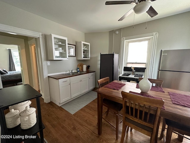 2935 S 3rd St, Louisville, KY 40208 - kitchen with freestanding refrigerator, glass insert cabinets, wood finished floors, a sink, and ceiling fan