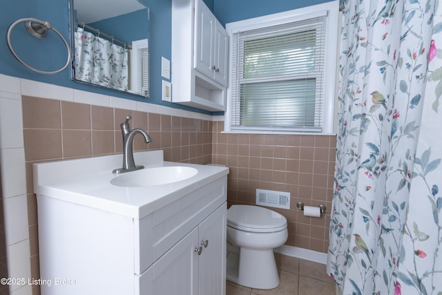 3553 Terrier Ln, Louisville, KY 40218 - bathroom featuring tile walls, toilet, tile patterned flooring, vanity, and curtained shower