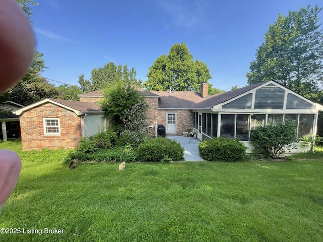 105 Hurstland Ct, Bardstown, KY 40004 - back of house with a sunroom, brick siding, a chimney, and a lawn