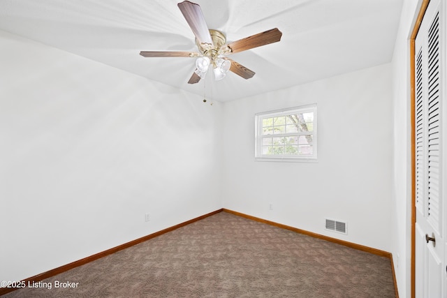 unfurnished bedroom with a closet, carpet, baseboards, and ceiling fan
