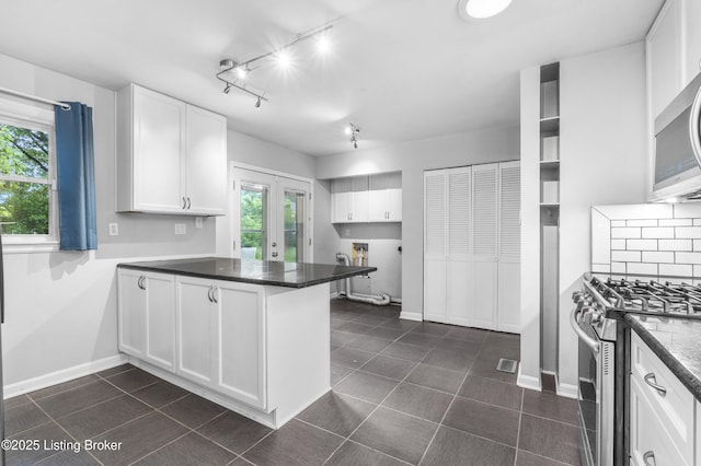 9201 Walhampton Ct, Louisville, KY 40242 - kitchen featuring appliances with stainless steel finishes, a peninsula, white cabinetry, and dark countertops