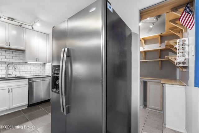9201 Walhampton Ct, Louisville, KY 40242 - kitchen featuring appliances with stainless steel finishes, a sink, tile patterned floors, decorative backsplash, and track lighting