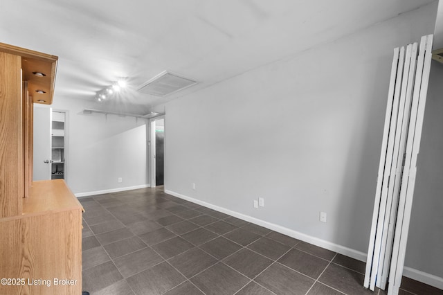9201 Walhampton Ct, Louisville, KY 40242 - empty room featuring attic access, dark tile patterned floors, and baseboards