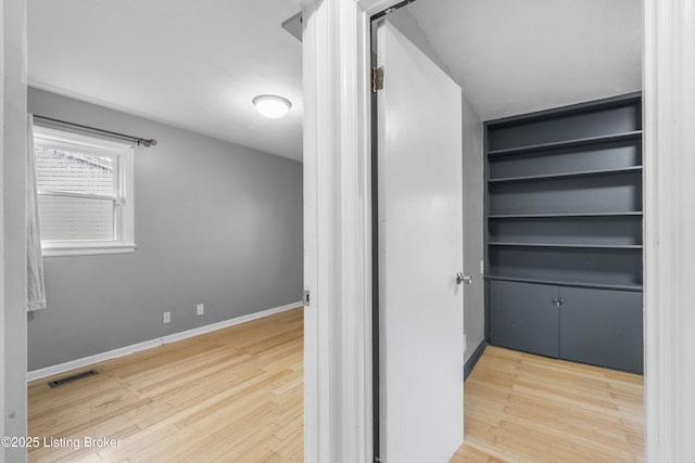 9201 Walhampton Ct, Louisville, KY 40242 - corridor featuring wood finished floors, baseboards, and built in shelves