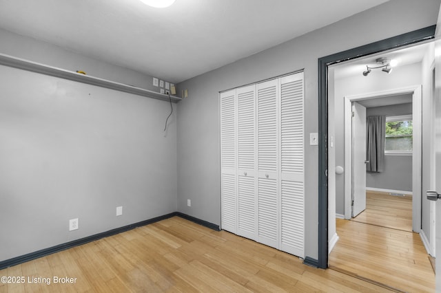 9201 Walhampton Ct, Louisville, KY 40242 - unfurnished bedroom with wood finished floors, a closet, and baseboards