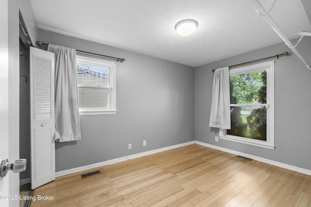 9201 Walhampton Ct, Louisville, KY 40242 - unfurnished bedroom featuring multiple windows, baseboards, and wood finished floors
