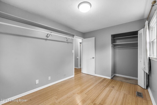 9201 Walhampton Ct, Louisville, KY 40242 - unfurnished bedroom with hardwood / wood-style flooring, a closet, and baseboards