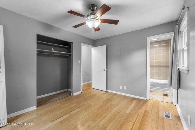 9201 Walhampton Ct, Louisville, KY 40242 - unfurnished bedroom featuring a closet, wood finished floors, baseboards, ensuite bath, and ceiling fan