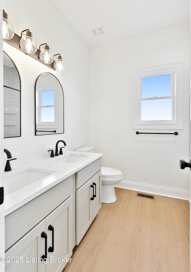 449 S Stallard Dr, Shelbyville, KY 40065 - bathroom featuring wood finished floors, double vanity, baseboards, and toilet