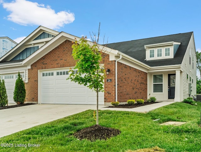 124 Exploration Path, Shelbyville, KY 40065 - view of front of house with a garage, concrete driveway, a front lawn, brick siding, and central air condition unit
