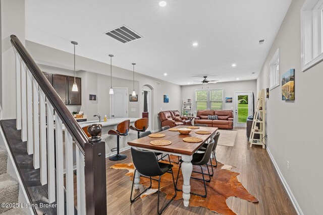 124 Exploration Path, Shelbyville, KY 40065 - dining area featuring dark wood-style floors, ceiling fan, recessed lighting, arched walkways, and baseboards